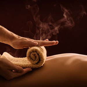 Top Vegas Massage Escort Angelica close up of hot steamy towel roled out on back.